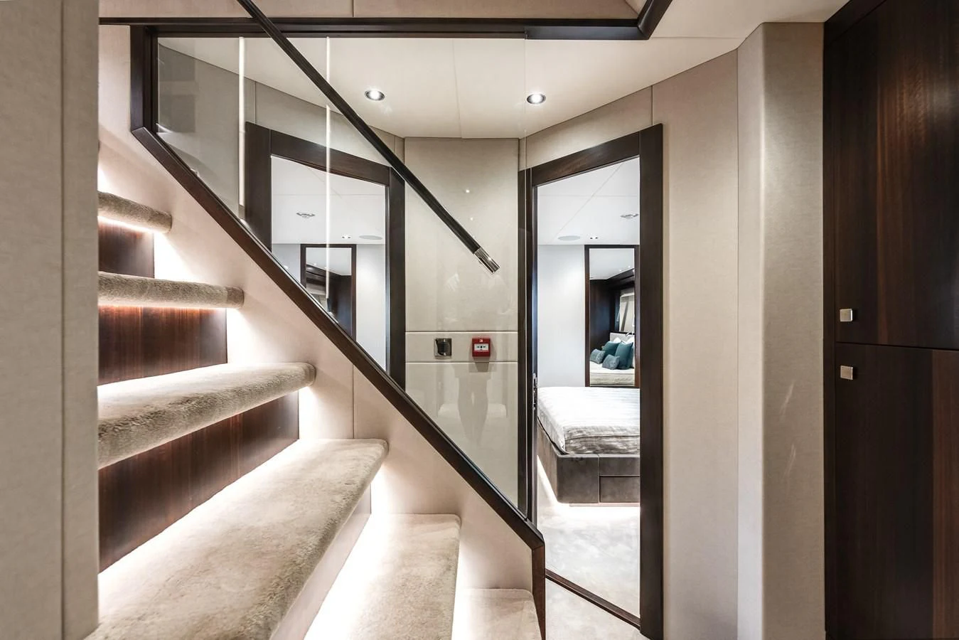 a hallway with glass doors aboard TRIGGER HAPPY Yacht for Sale