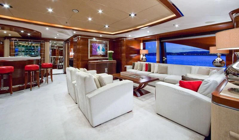 a room with a couch and a table and chairs aboard LADY BRAVE Yacht for Sale