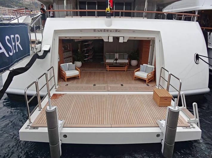 a large white building with a bench and chairs aboard LADY BRAVE Yacht for Sale