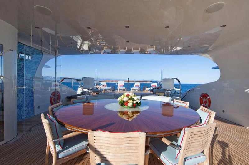 a table with chairs and a view of the ocean aboard LADY BRAVE Yacht for Sale