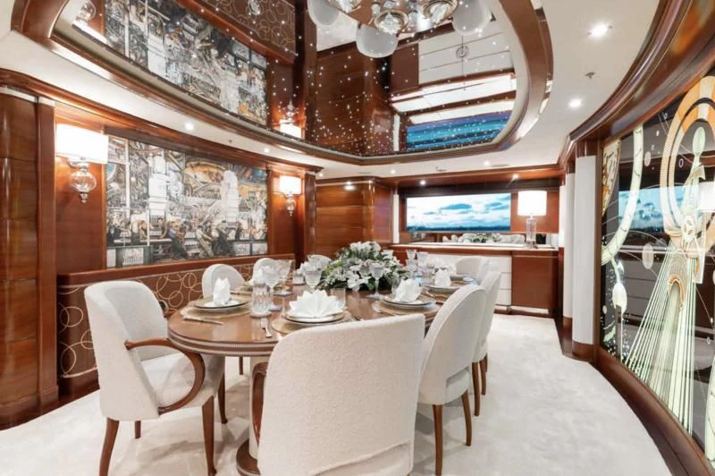 a room with a table and chairs aboard LADY BRAVE Yacht for Sale