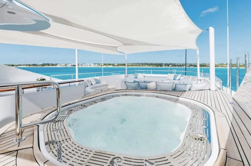 a swimming pool with a large white building and a large pool aboard LADY BRAVE Yacht for Sale