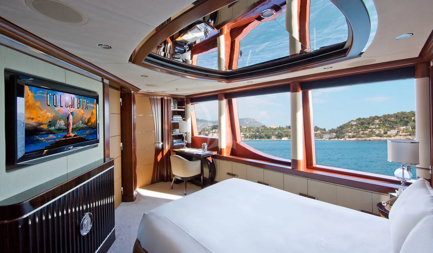 a room with a bed and a television aboard LADY BRAVE Yacht for Sale