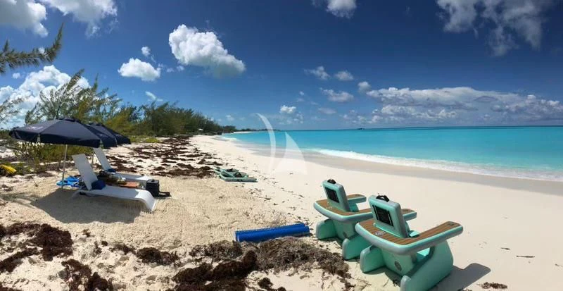 chairs and umbrellas on a beach aboard LADY BRAVE Yacht for Sale