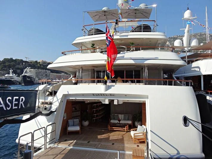 a large white boat with flags aboard LADY BRAVE Yacht for Sale