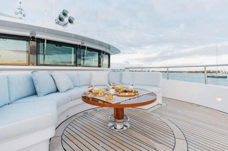 a living room with a table and a couch aboard LADY BRAVE Yacht for Sale