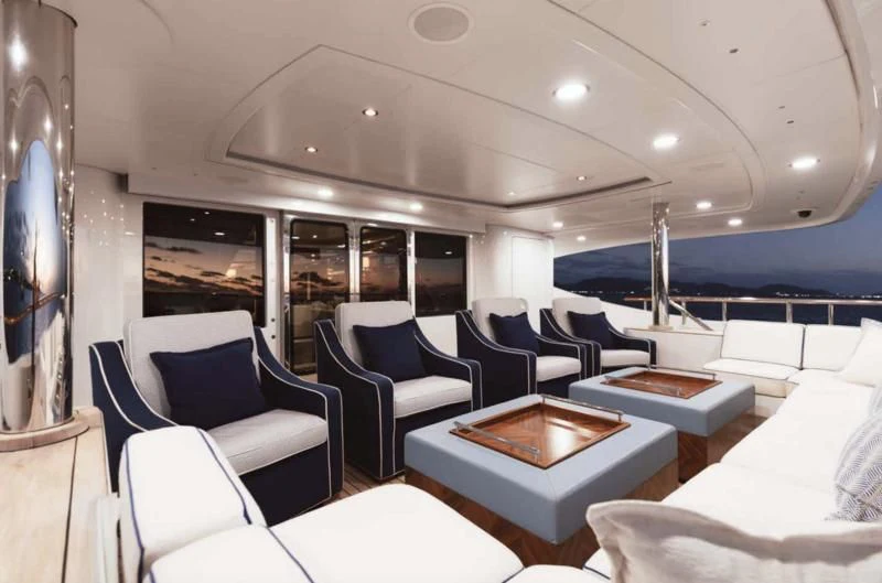 a room with a table chairs and a large window aboard LADY BRAVE Yacht for Sale