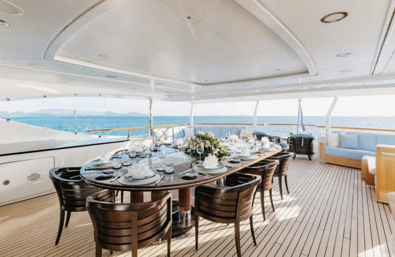 a dining table on a deck aboard LADY BRAVE Yacht for Sale