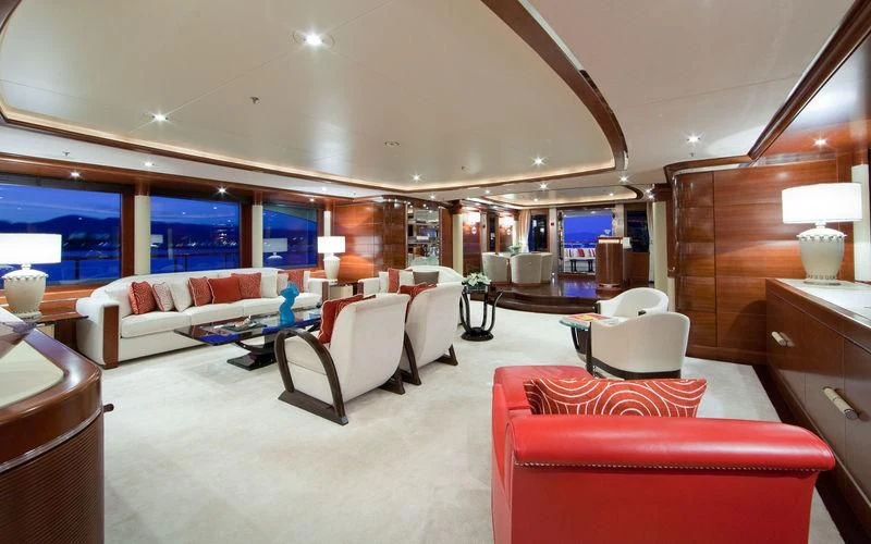 a room with a couch and a table and chairs aboard LADY BRAVE Yacht for Sale