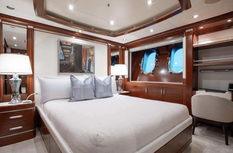 a bed with a white bed spread aboard LADY BRAVE Yacht for Sale