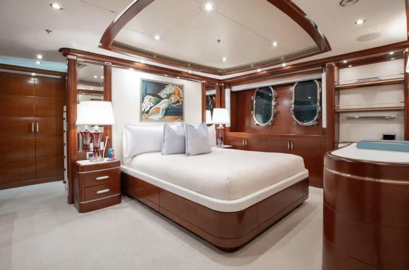 a bedroom with a bed and a mirror aboard LADY BRAVE Yacht for Sale