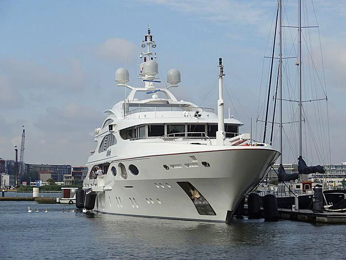 a large white boat in a harbor aboard LADY BRAVE Yacht for Sale