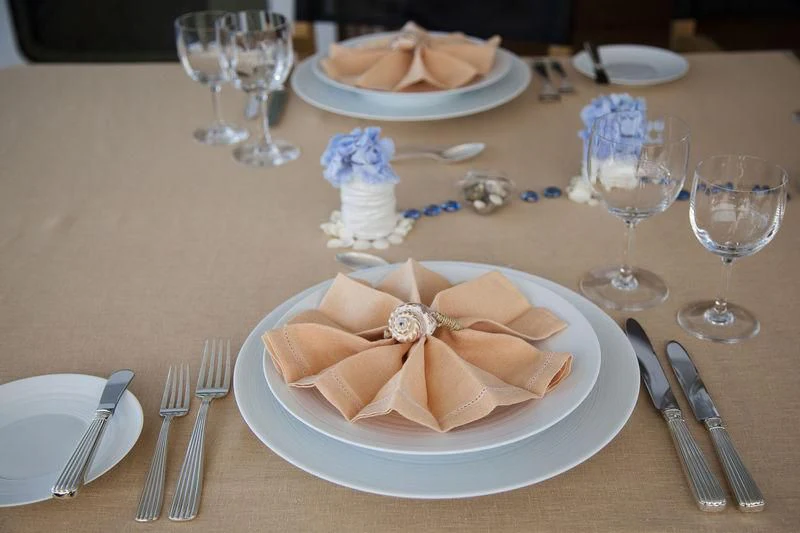 a table with plates of food and silverware aboard LADY BRAVE Yacht for Sale