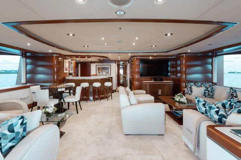 a living room with a couch and a table aboard LADY BRAVE Yacht for Sale
