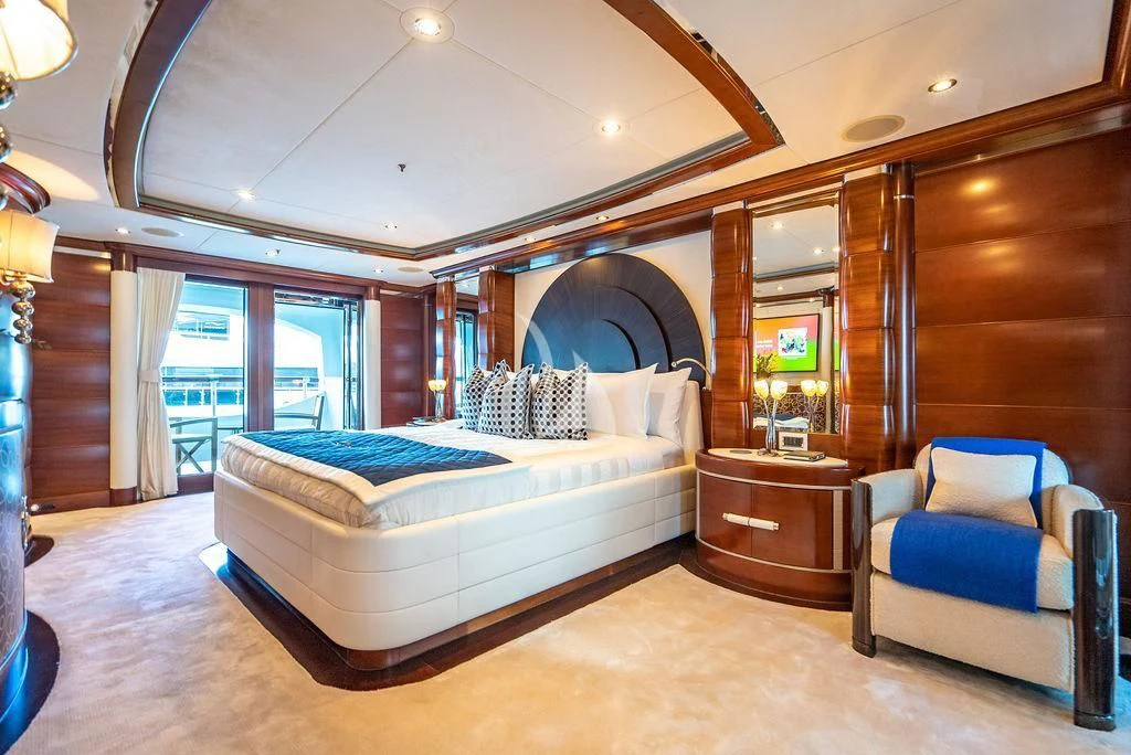 a bedroom with a large mirror aboard LADY BRAVE Yacht for Sale