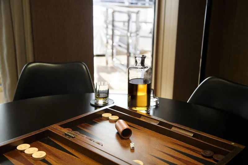 a table with a glass of beer and a bottle of beer aboard LADY BRAVE Yacht for Sale