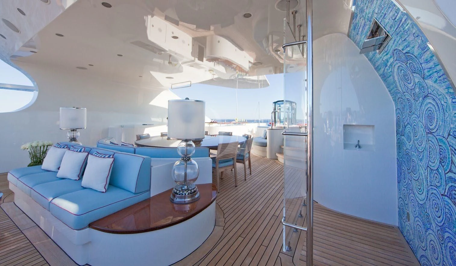 a room with a large bed and a table with a lamp aboard LADY BRAVE Yacht for Sale