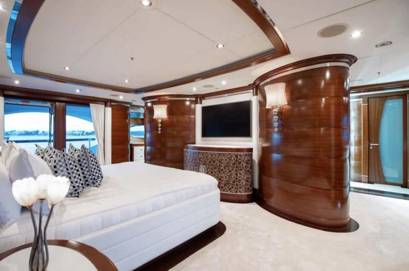 a room with a bed and a television aboard LADY BRAVE Yacht for Sale