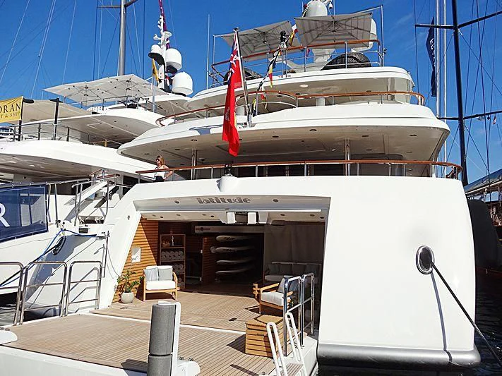 a large white boat with a red and white stripe aboard LADY BRAVE Yacht for Sale