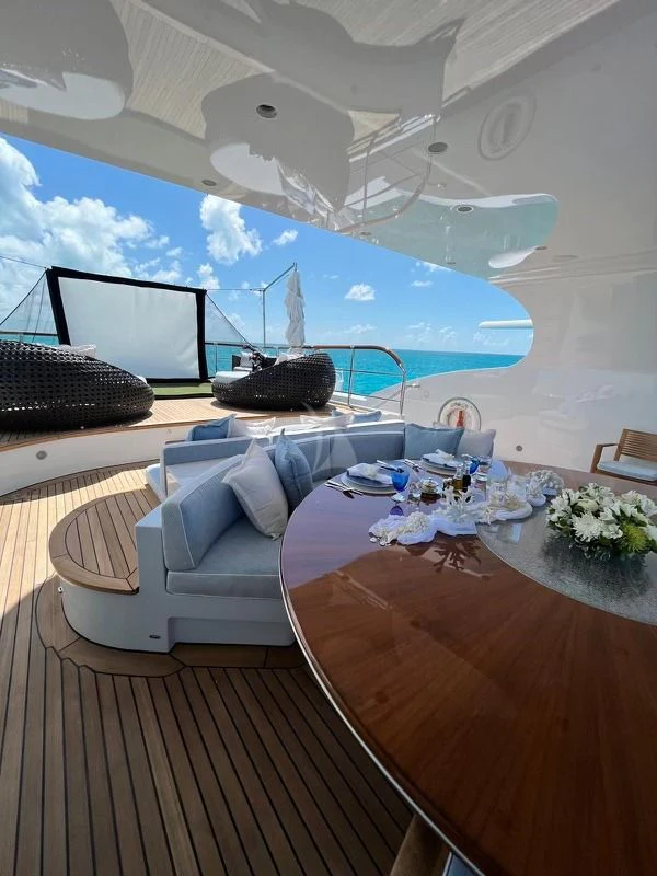 a room with a table and chairs aboard LADY BRAVE Yacht for Sale