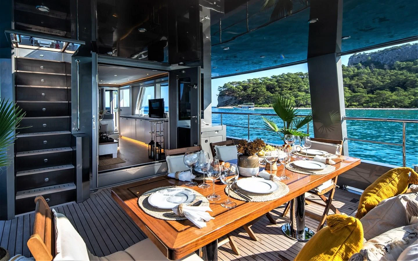 a dining table on a deck aboard BERING B82 Yacht for Sale