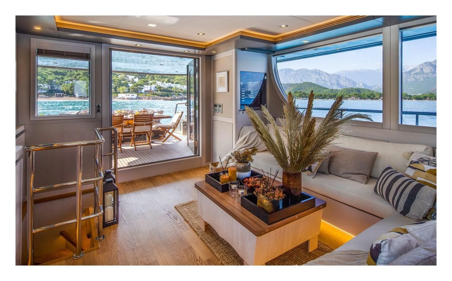a living room with a table and a plant aboard BERING B82 Yacht for Sale