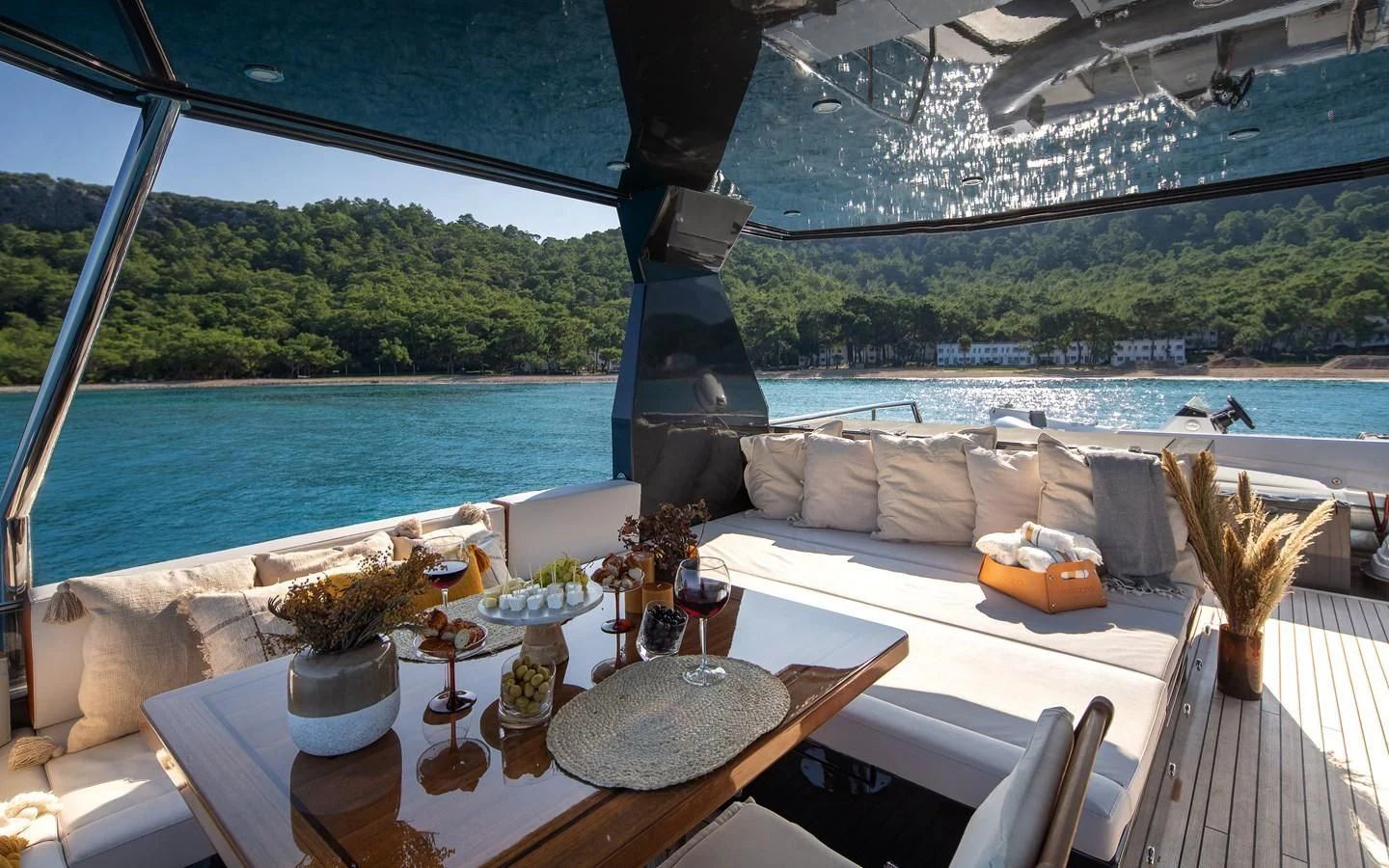 a table with a glass window overlooking a body of water aboard BERING B82 Yacht for Sale