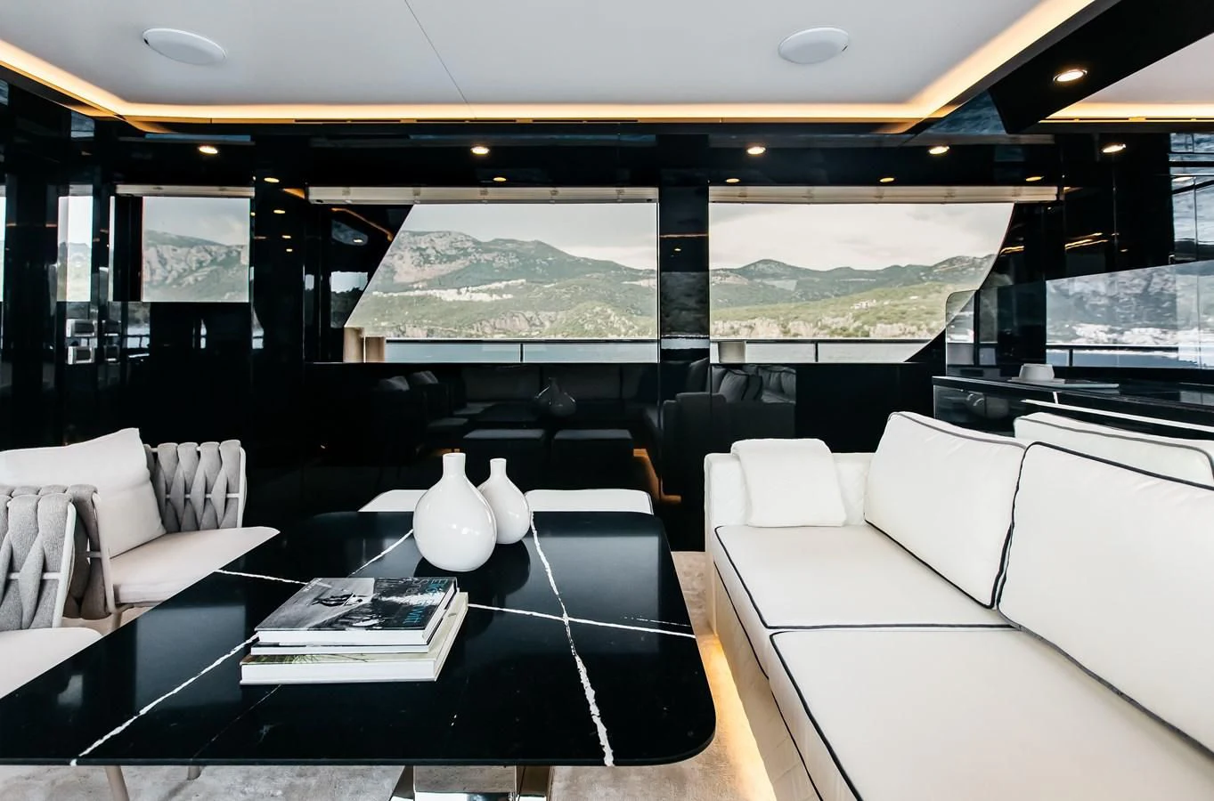 a room with a table and chairs aboard BERING B82 Yacht for Sale