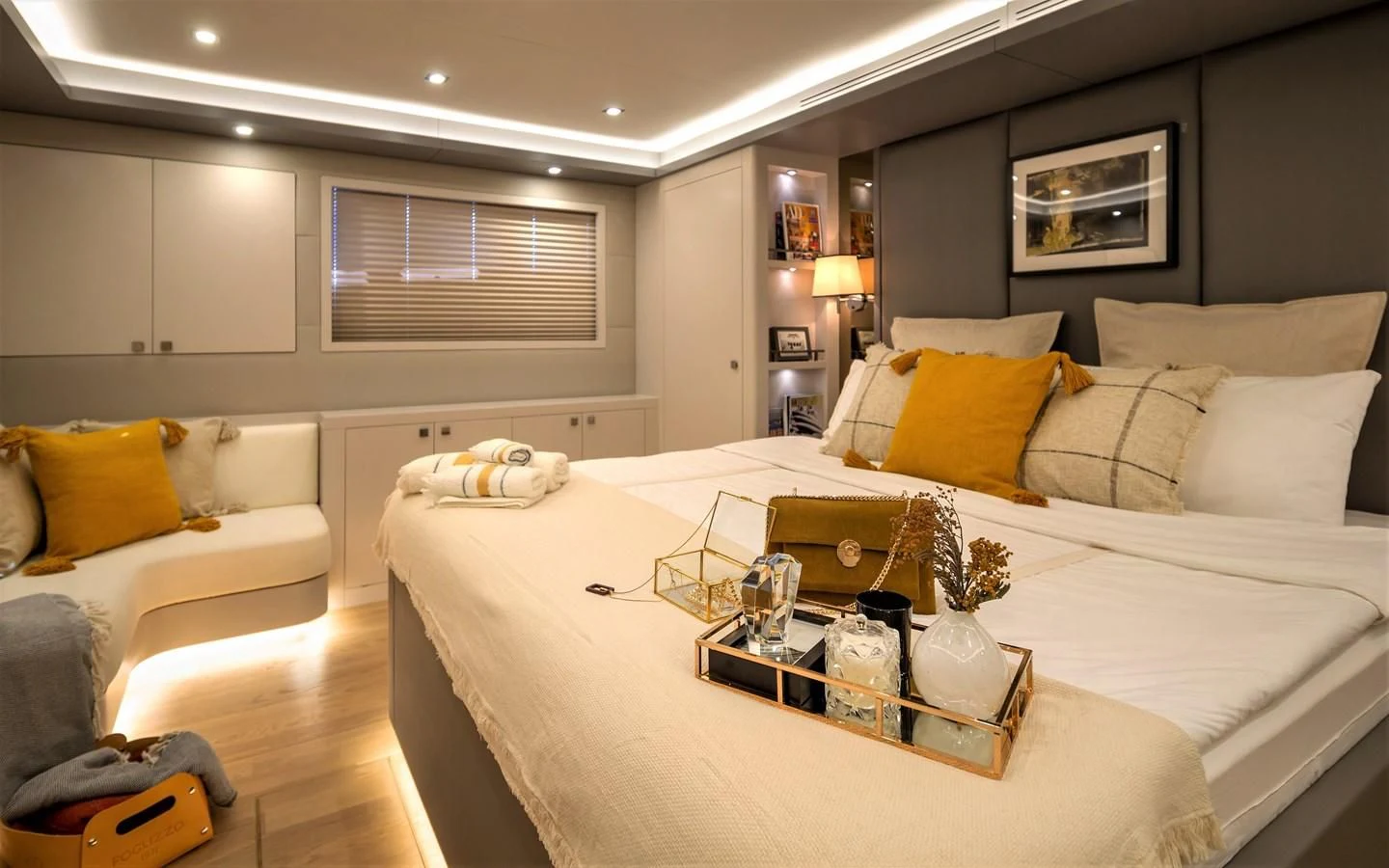 a bed with a white sheet and yellow pillows aboard BERING B82 Yacht for Sale