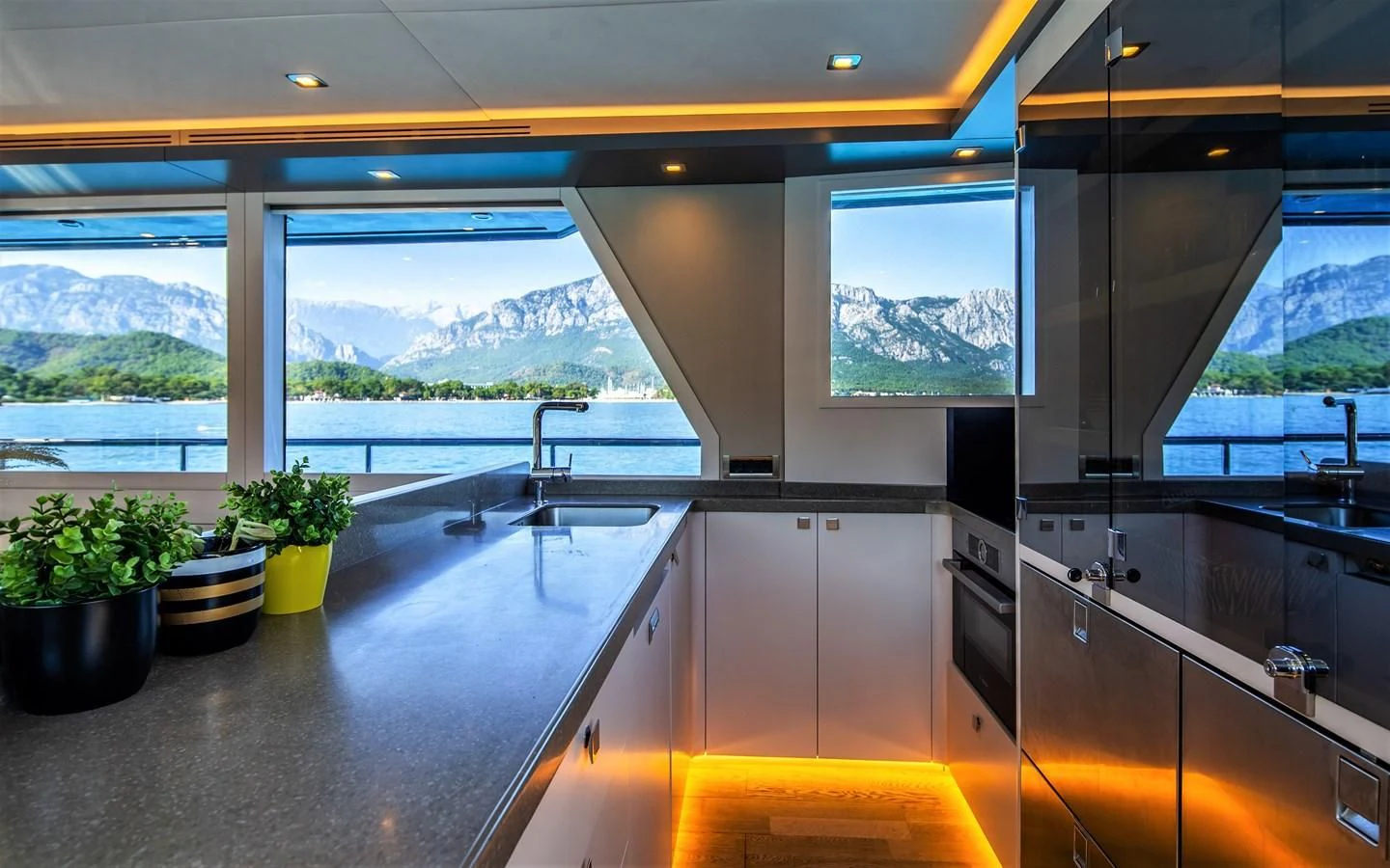a kitchen with a large island aboard BERING B82 Yacht for Sale
