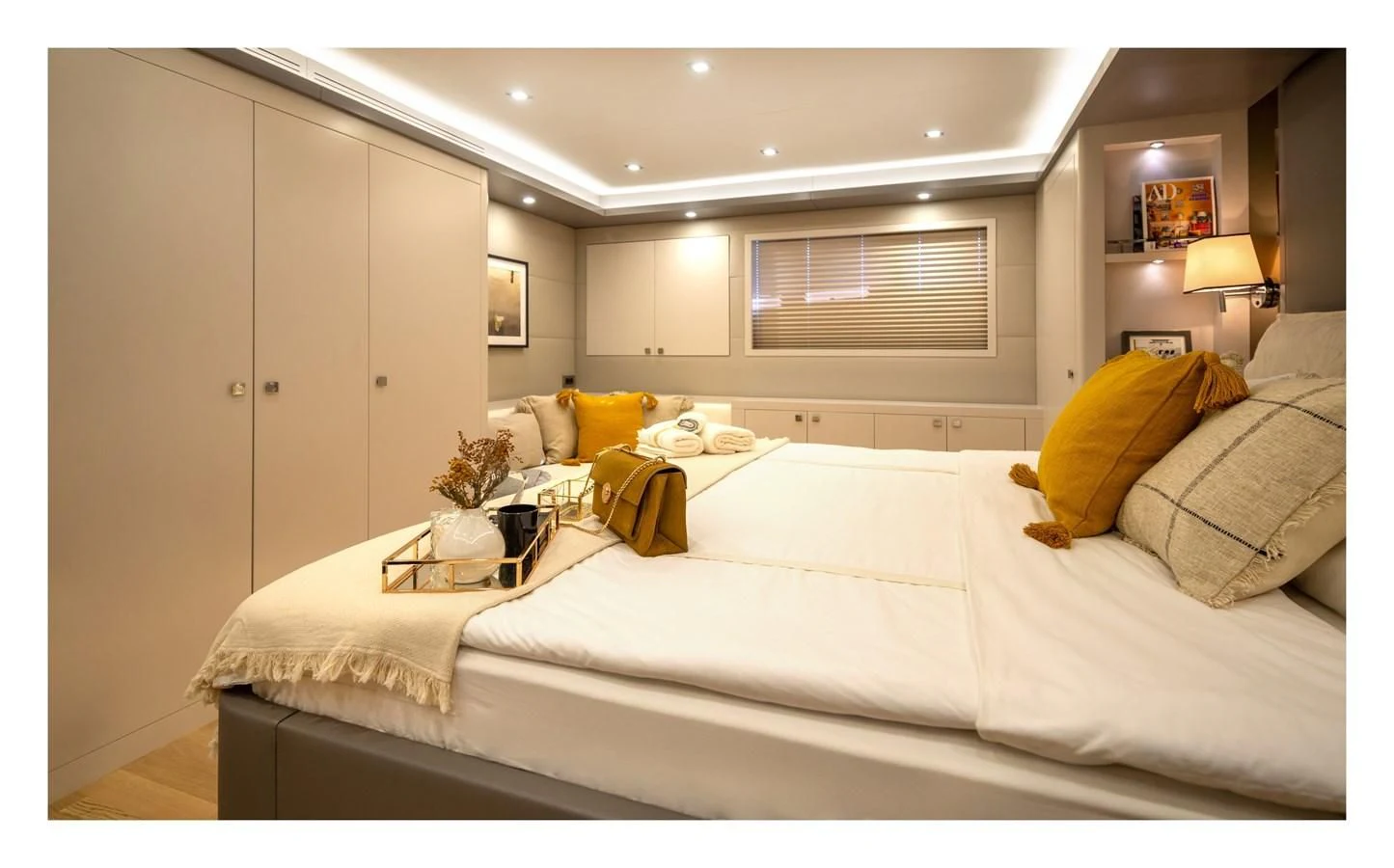 a bedroom with a bed and a lamp aboard BERING B82 Yacht for Sale