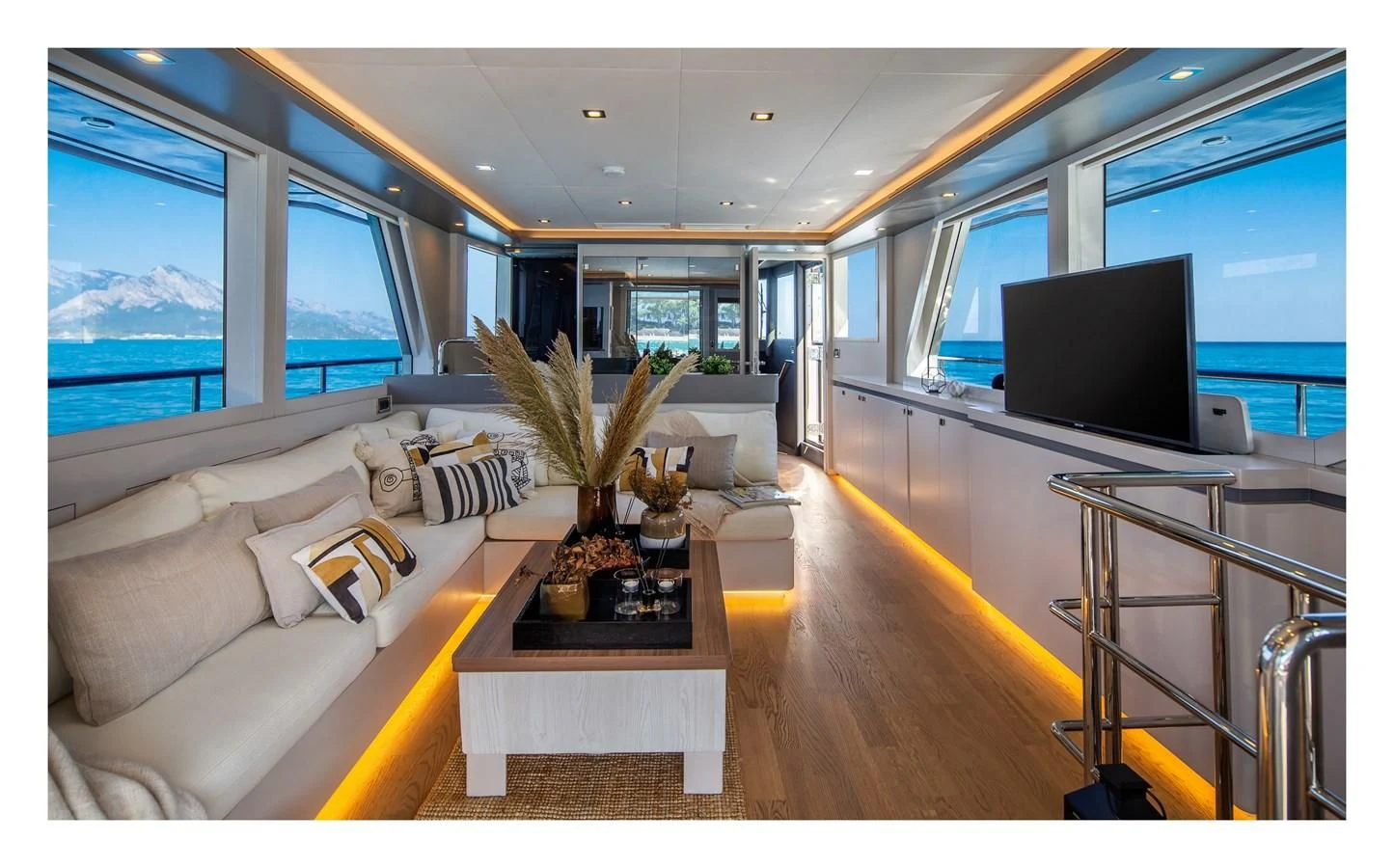a living room with a large window aboard BERING B82 Yacht for Sale