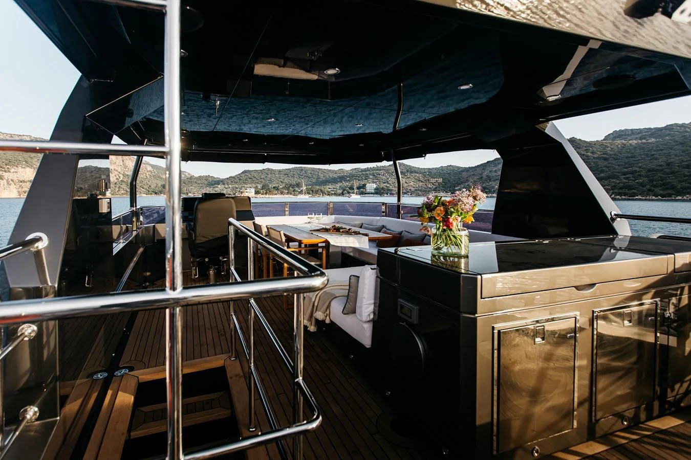a boat with a table and chairs aboard BERING B82 Yacht for Sale