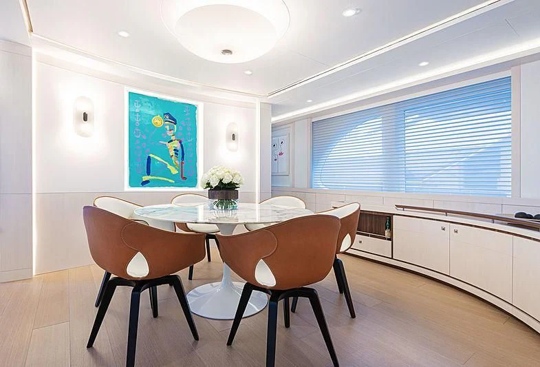 a kitchen with a table and chairs aboard VANADIS Yacht for Sale