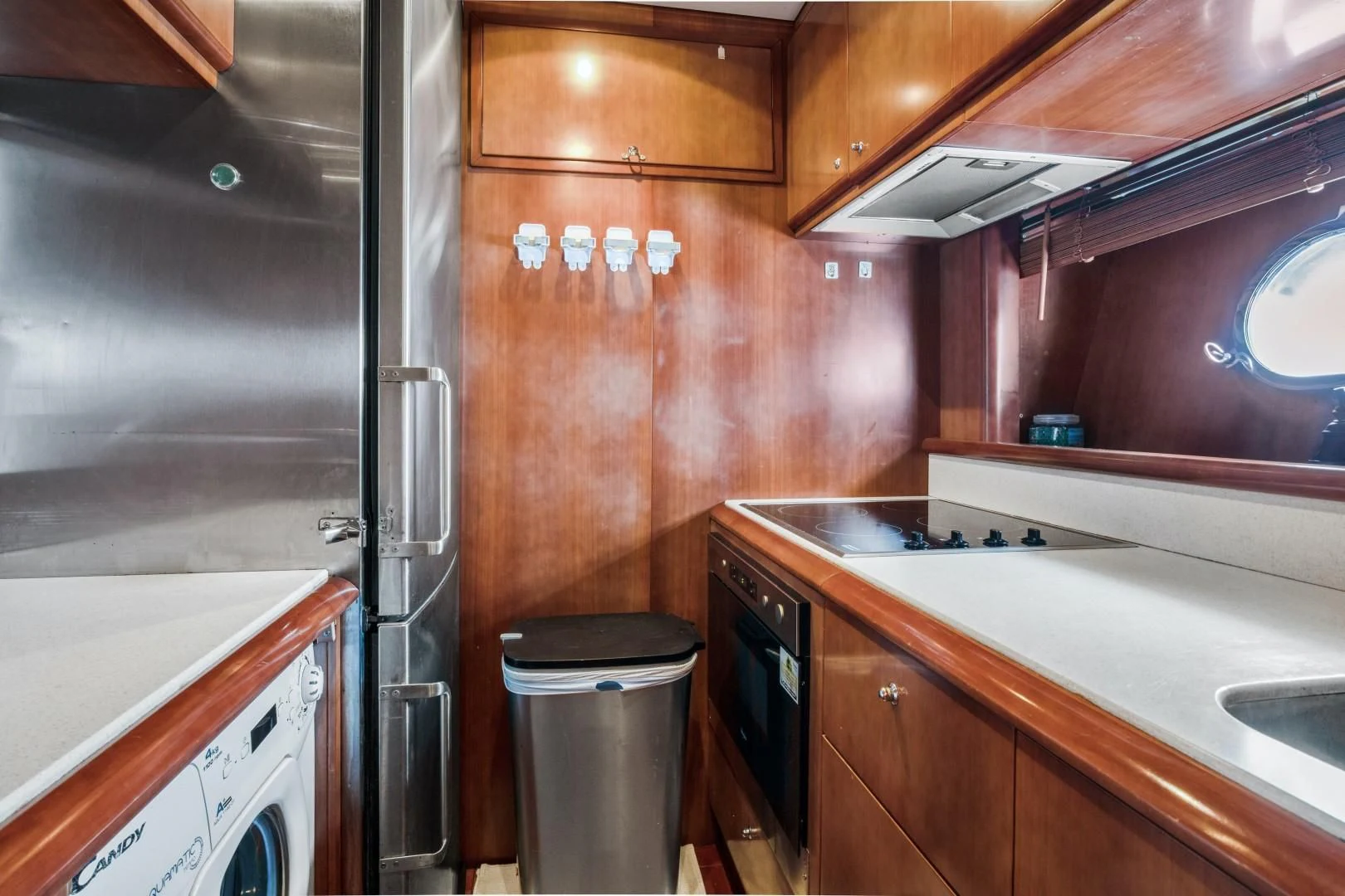 a kitchen with wooden cabinets aboard ALCHEMY Yacht for Sale