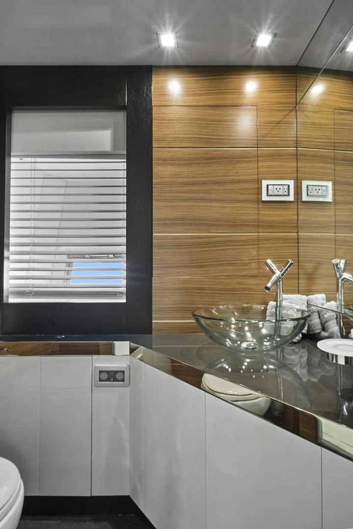 a bathroom with a glass bowl aboard EL PATRON Yacht for Sale