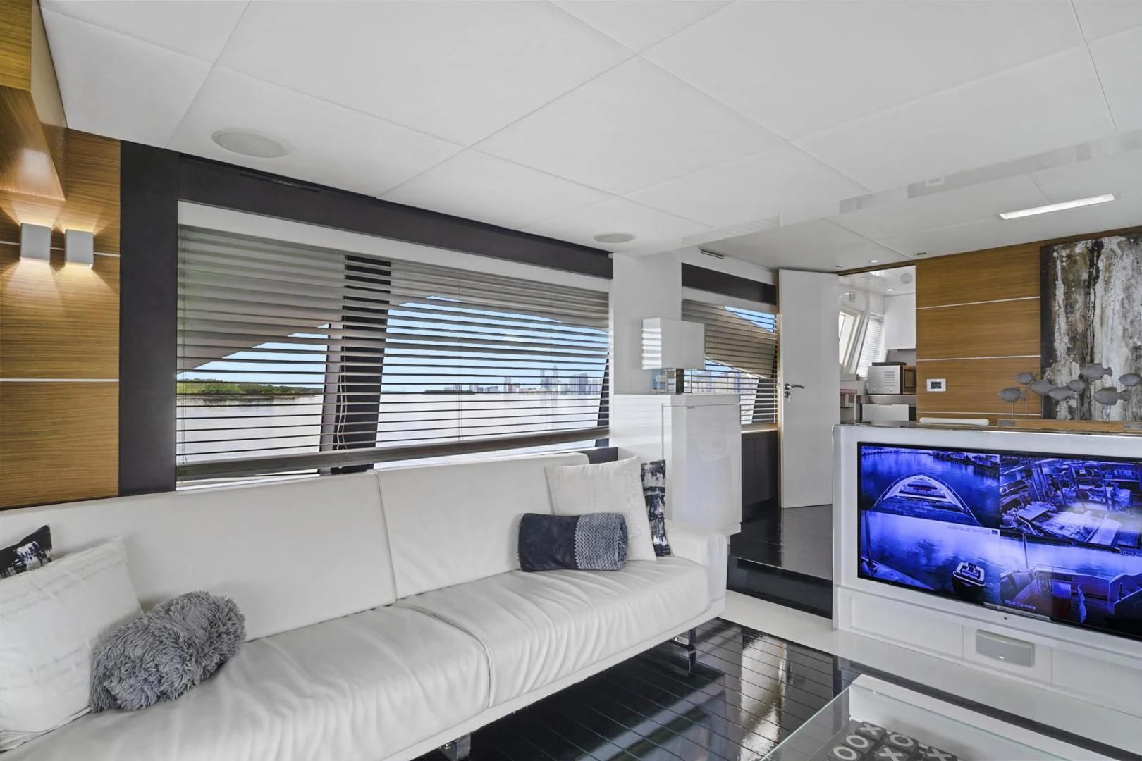 a living room with a large screen aboard EL PATRON Yacht for Sale