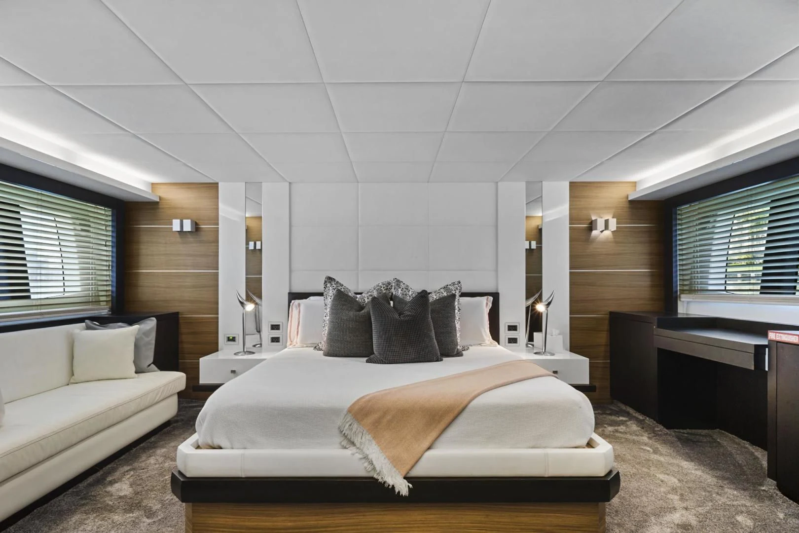 a bedroom with a bed and a mirror aboard EL PATRON Yacht for Sale