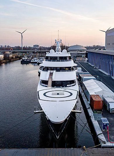 a large white ship in a harbor aboard SYMPHONY Yacht for Sale