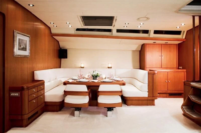 a room with a table and couch aboard ABEON Yacht for Charter