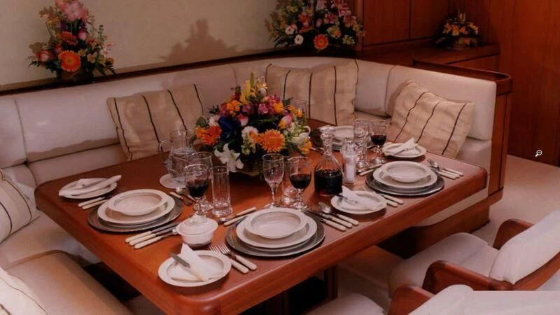 a table set with plates and glasses aboard ABEON Yacht for Charter