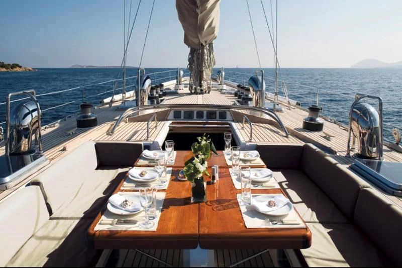a table with plates and glasses on it on a boat aboard ABEON Yacht for Charter