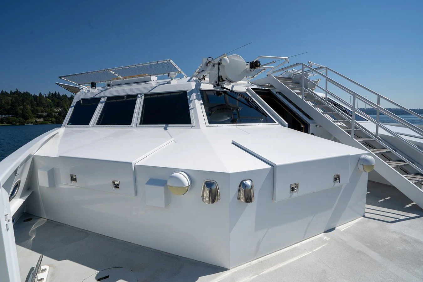 a white yacht on a dock aboard DRAGONFLY Yacht for Sale