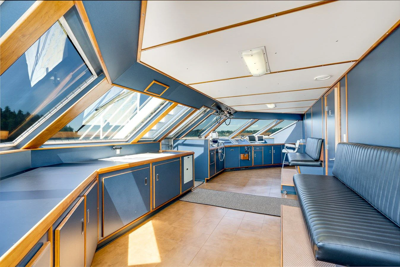a room with a couch and a table aboard DRAGONFLY Yacht for Sale