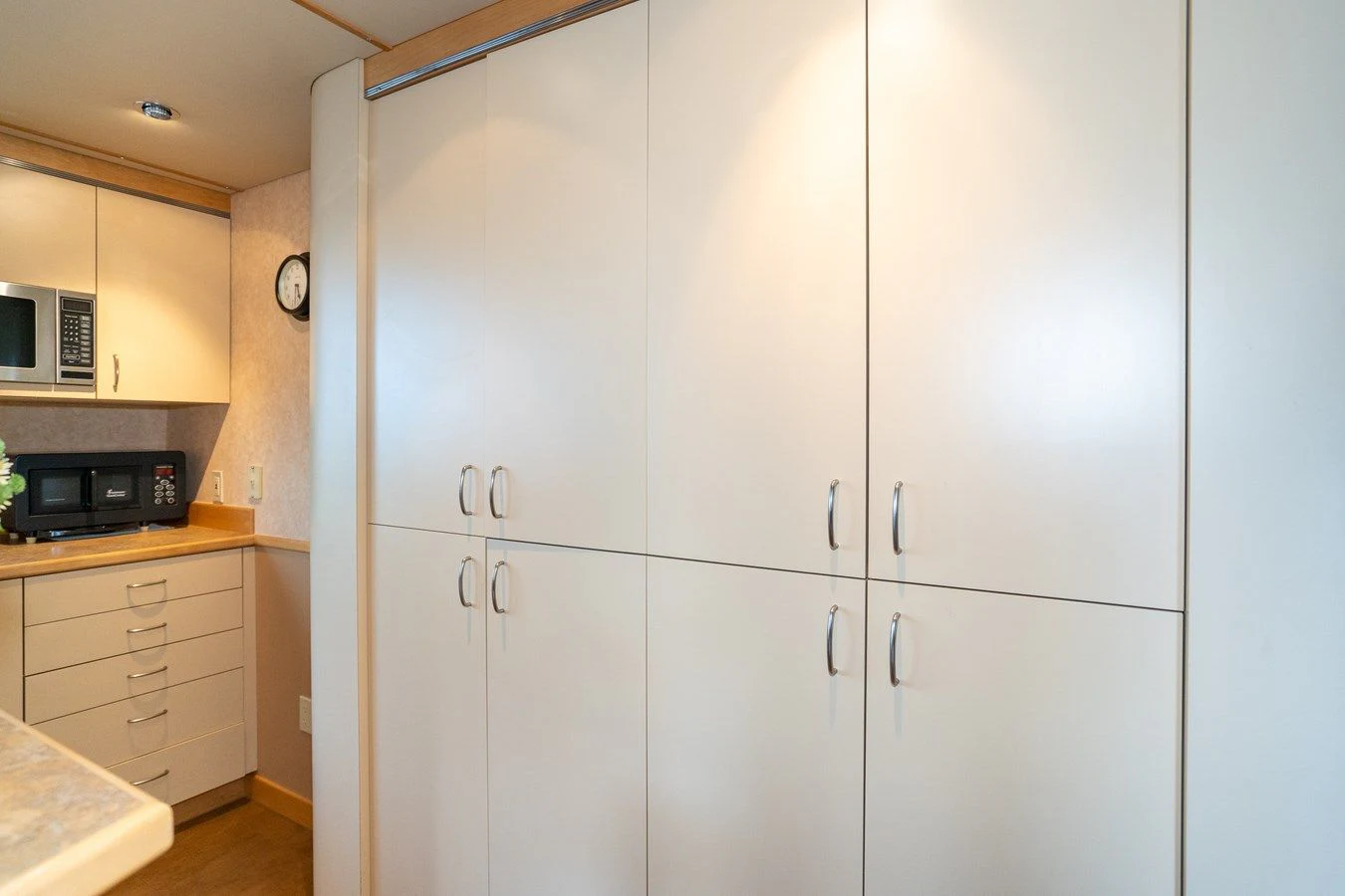 a white kitchen with a white wall aboard DRAGONFLY Yacht for Sale