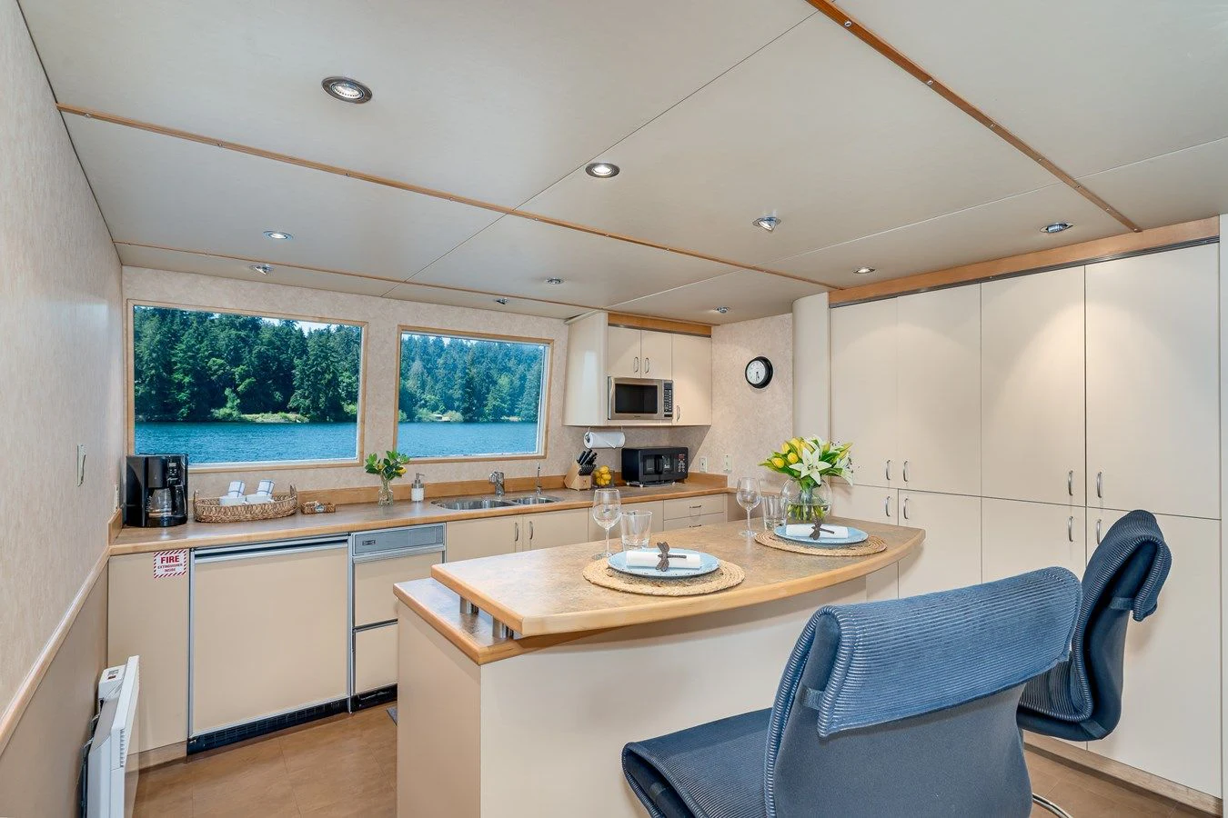 a kitchen with a table and chairs aboard DRAGONFLY Yacht for Sale