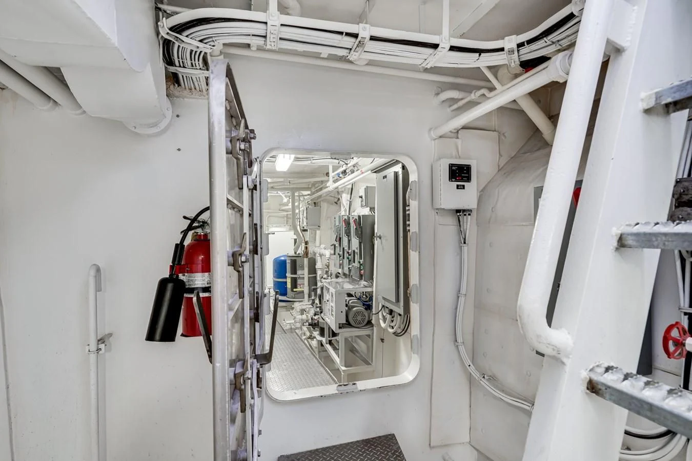 a white room with pipes and equipment aboard DRAGONFLY Yacht for Sale