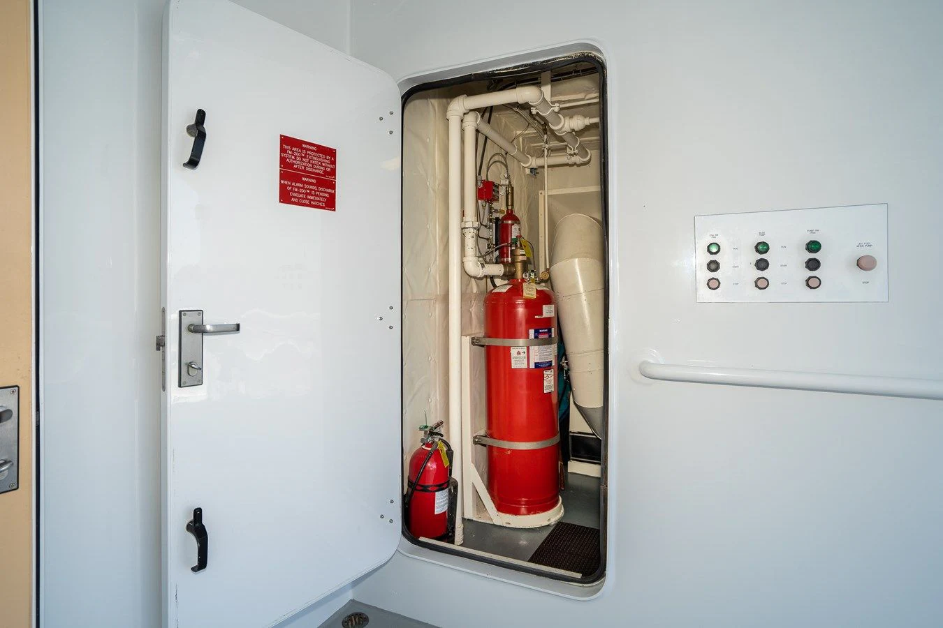 a fire extinguisher in a closet aboard DRAGONFLY Yacht for Sale