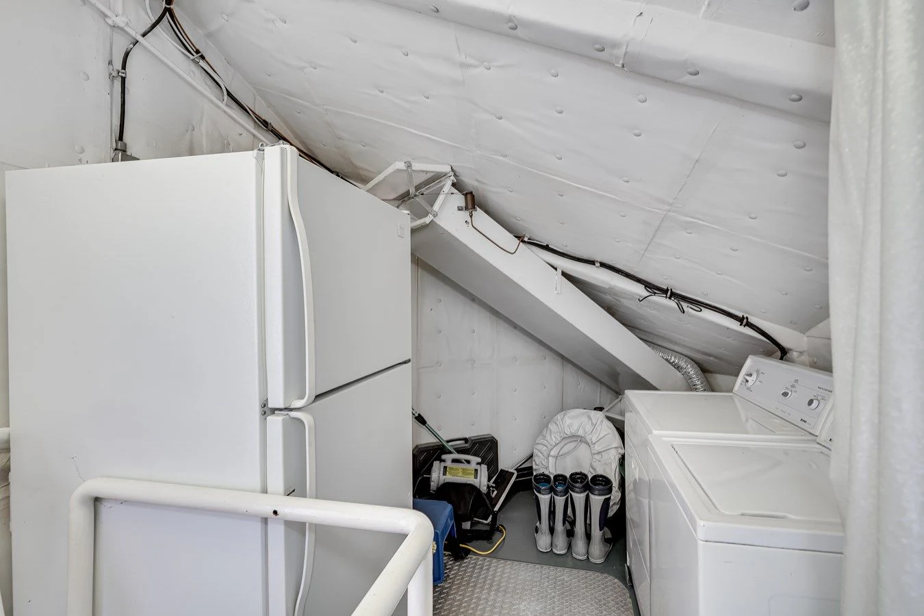 a white refrigerator in a room aboard DRAGONFLY Yacht for Sale