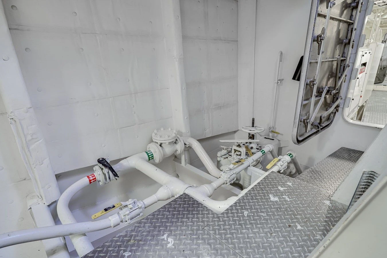 a white room with pipes and equipment aboard DRAGONFLY Yacht for Sale